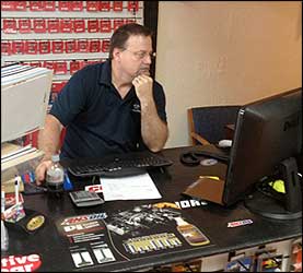 Tim looking up products for a customer wanting his vehicle to last a long time